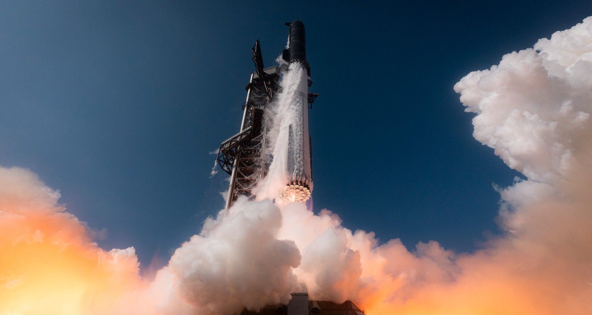 a large silver rocket launches above a plume of fire