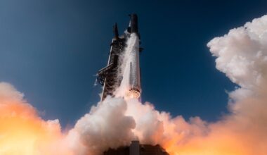 a large silver rocket launches above a plume of fire
