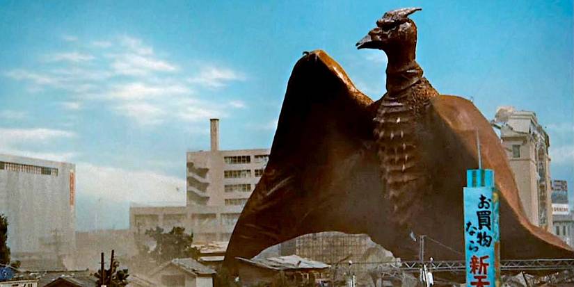 Rodan walking through a city
