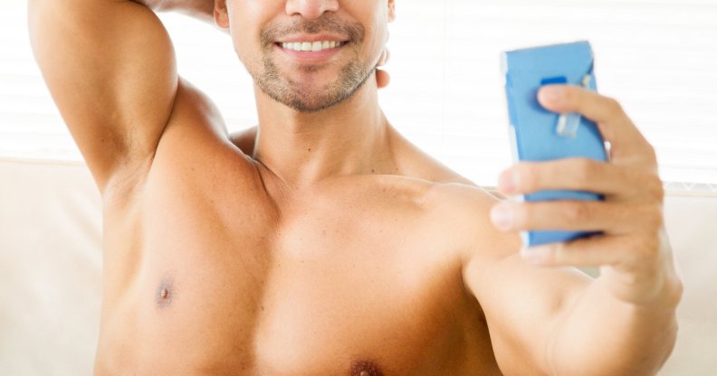 shirtless man using phone