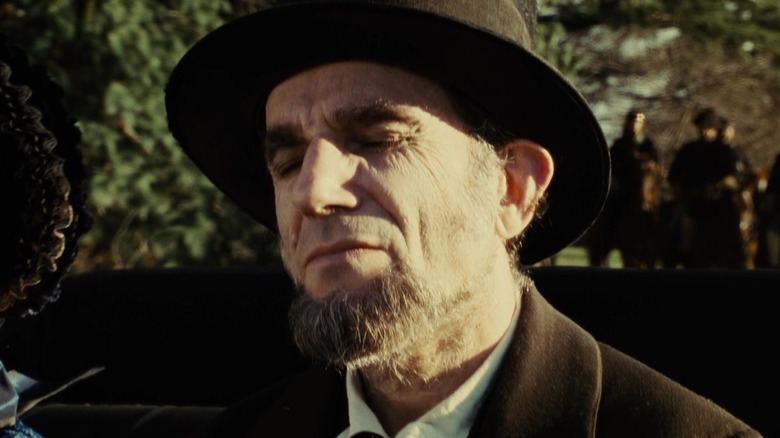 Daniel Day-Lewis as Abraham Lincoln riding in a carriage in Lincoln