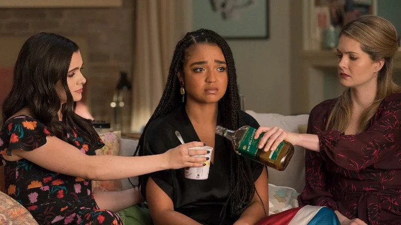 Katie Stevens as Jane, Aisha Dee as Kat, and Meghann Fahy as Sutton sitting on the couch in The Bold Type