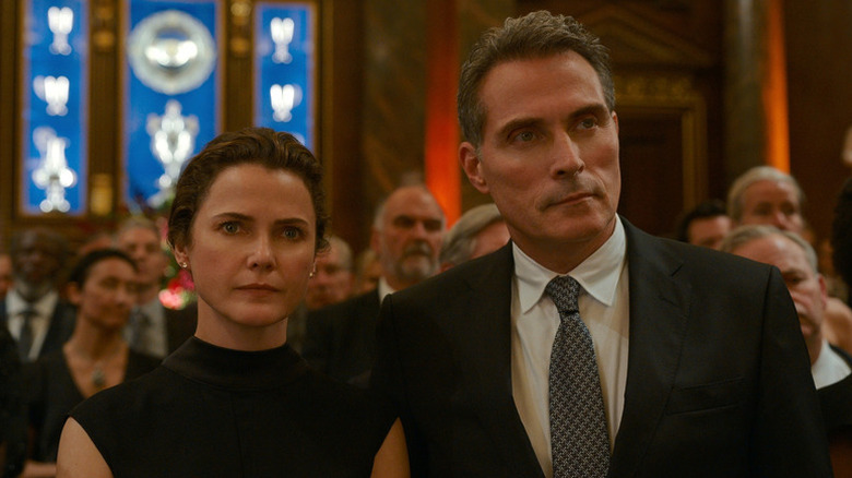 Keri Russell as Kate standing next to Rufus Sewell as Hal at fancy event in The Diplomat