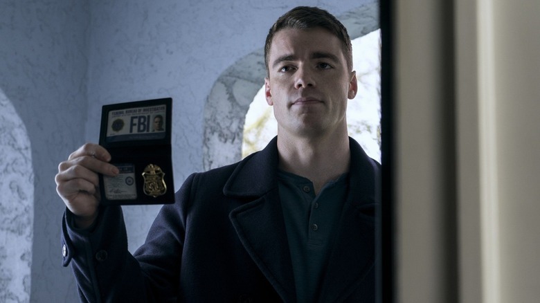 Peter Sutherland shows his FBI badge in The Night Agent