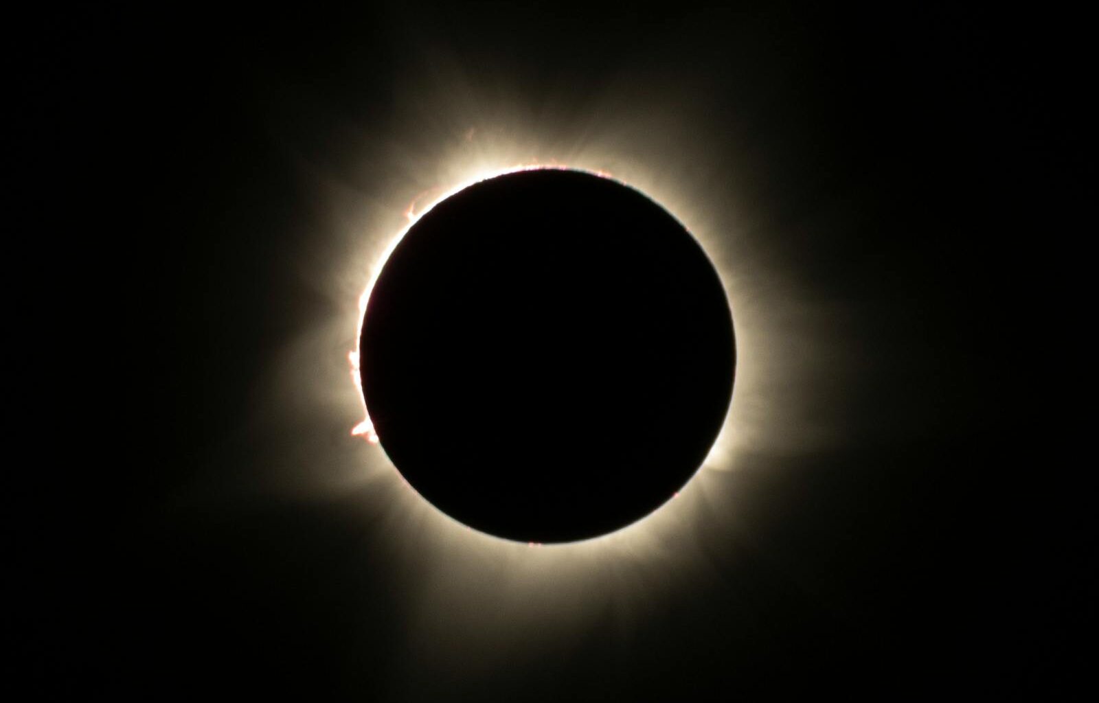 The Parker Solar Probe is now moving at 430,000 miles per hour, fast enough to cross the continental United States in 20 seconds, and it survives skimming the Sun's corona because a four-and-a-half-inch slab of carbon foam stays at room temperature on the side facing 2,500-degree plasma.