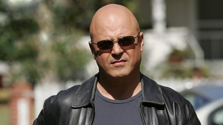 Michael Chiklis as Vic Mackey standing in sunglasses in The Shield