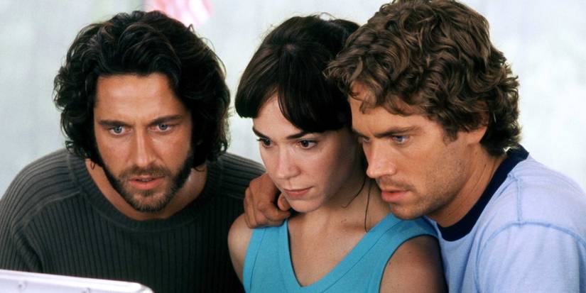 Gerard Butler, Frances O'Connor and Paul Walker look at a computer in Timeline