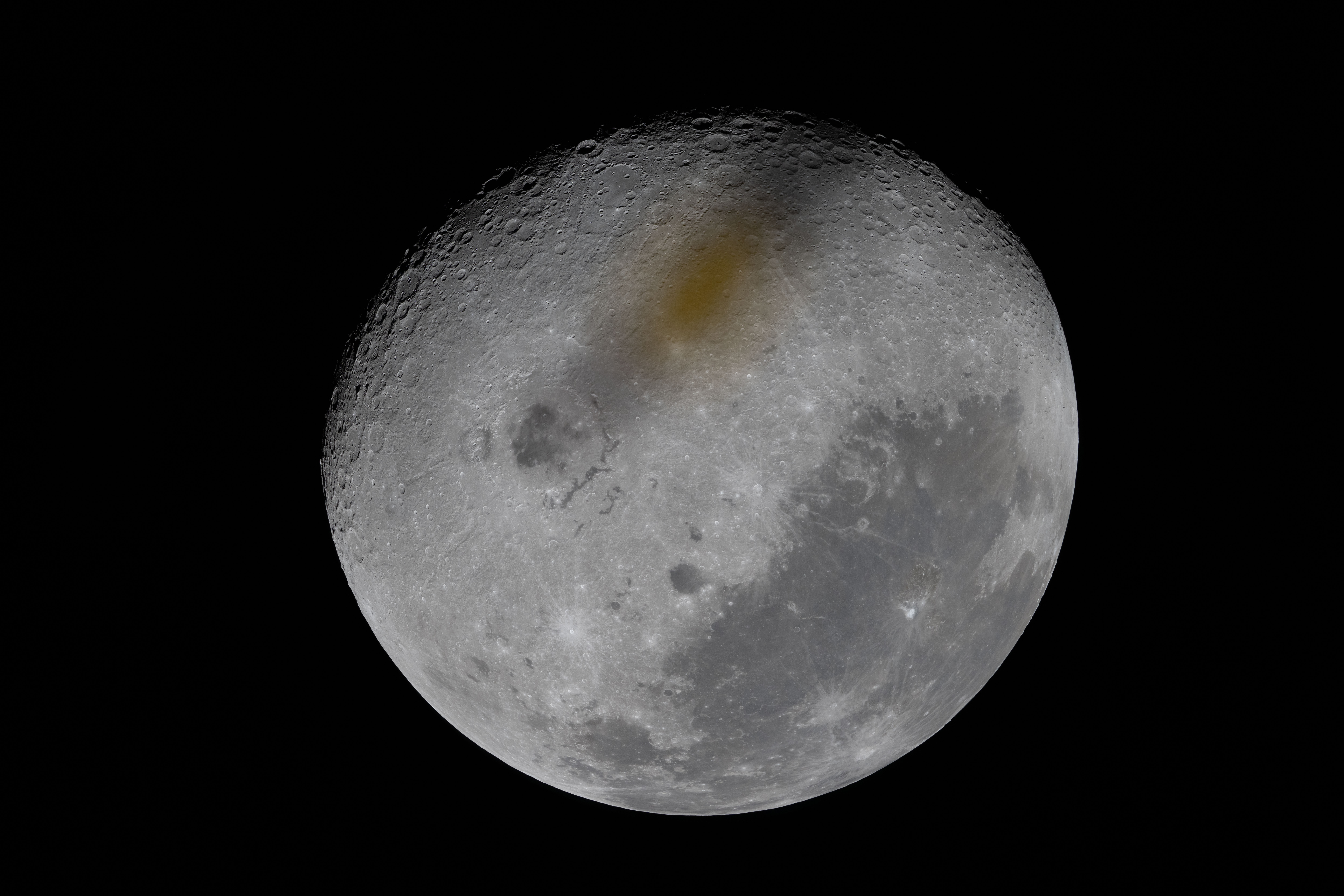a brown spot across the face of the moon