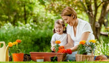Parent and child planting flowers.