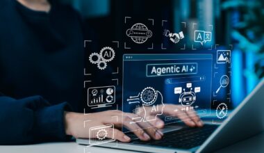A graphic of agentic AI surfaces above a laptop.