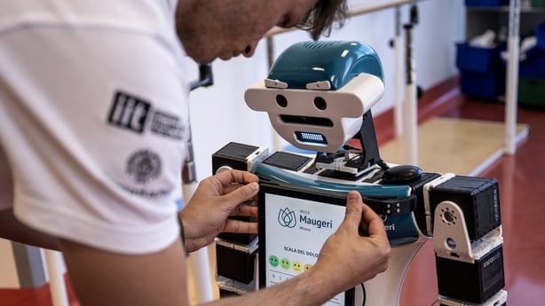 an engineer sets up humanoid robot Alter-Ego