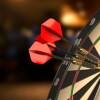 Dartboard with three darts in the bullseyes. 3D illustration