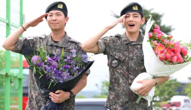 BTS members RM, left, and V salute after being discharged from the Army following their mandatory military service. Yonhap