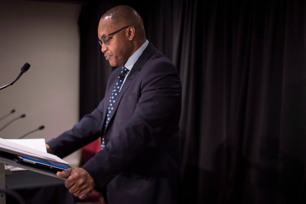 A man speaks at a podium