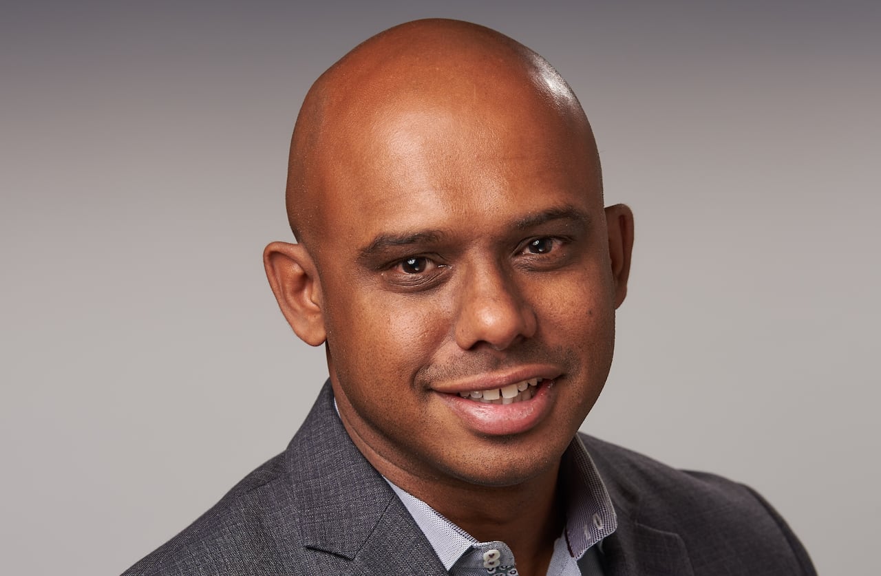 A man smiles at the camera