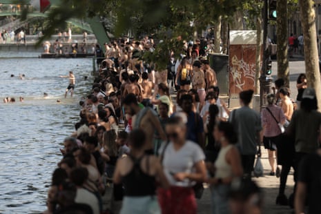 People swim at Canal Saint-Martin to cool off on Tuesday.