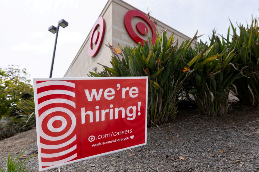 A sign posted outside a Target store states the company is hiring in Encinitas, California, March 30, 2026.
