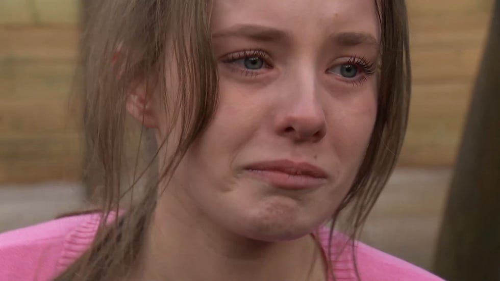 Hollyoaks Dee Dee Hutchinson crying hollyoaks, close up shot of dee dee hutchinson in a pink cardigan, crying and scrunching up her face