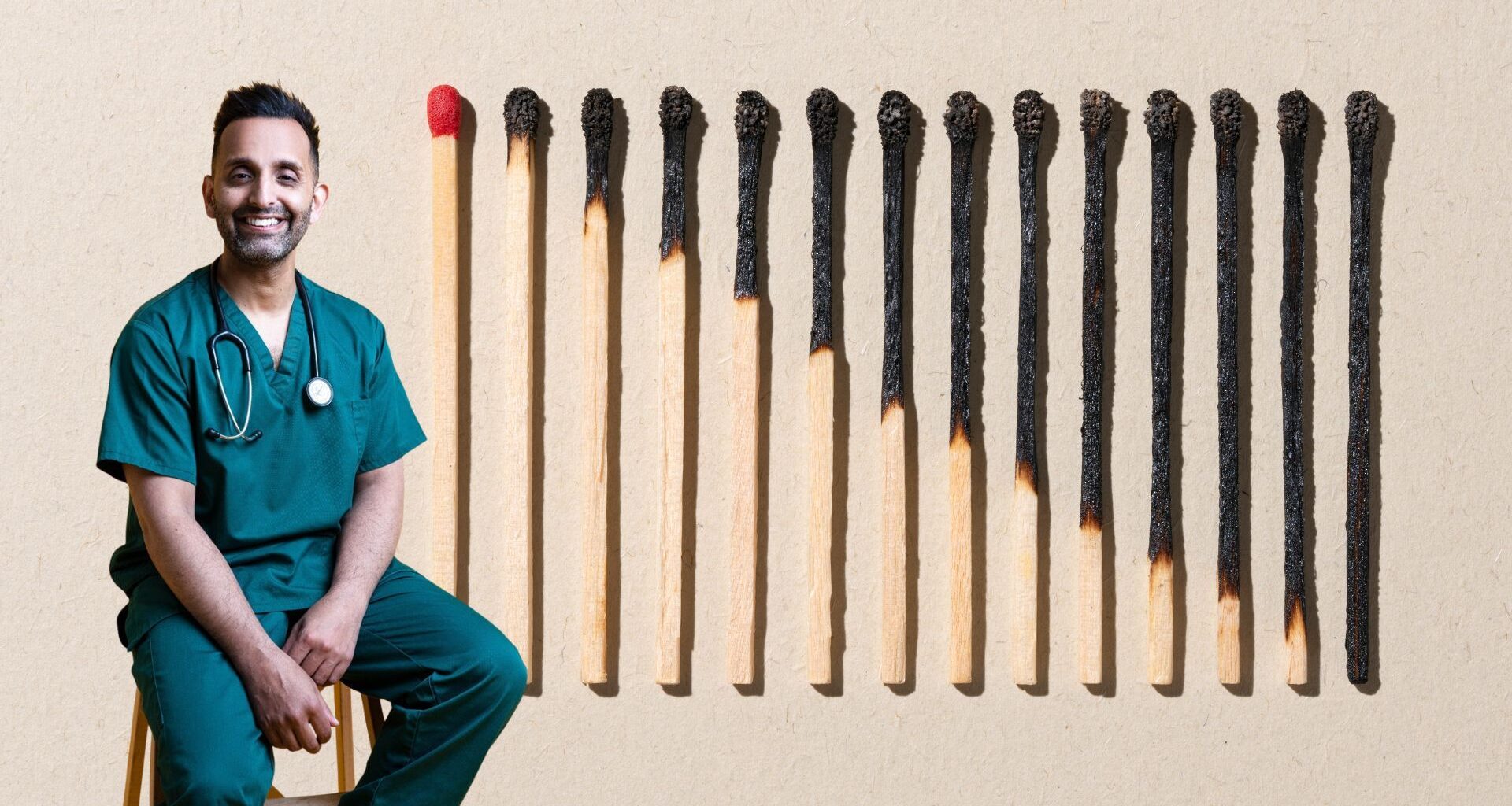 Dr Amir Khan next to burnt out matches, representing the physical signs of stress