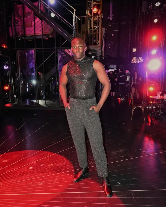 Love Island's Ope Sowande posing on stage.