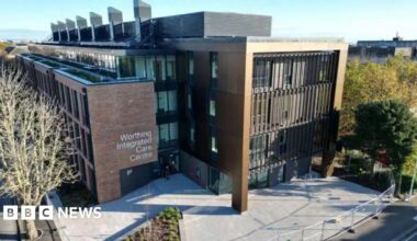 An aerial shot of the Worthing integrated care centre. It shows a brown building with a patio and trees in front.