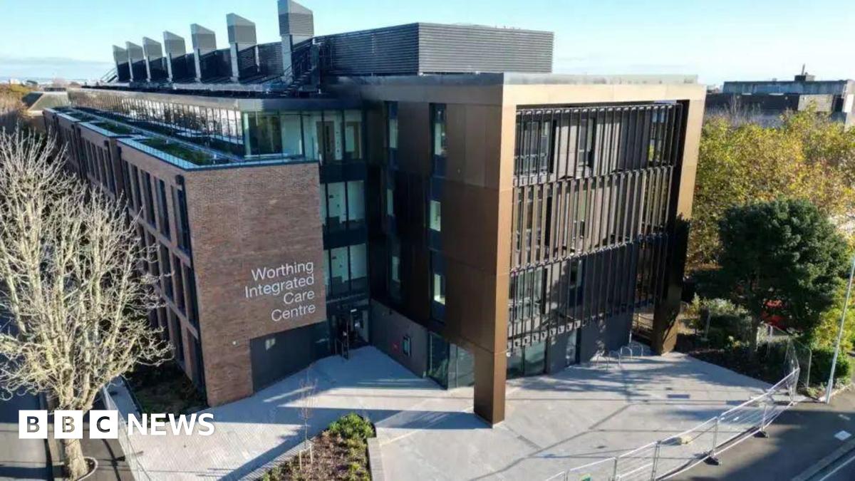 An aerial shot of the Worthing integrated care centre. It shows a brown building with a patio and trees in front.