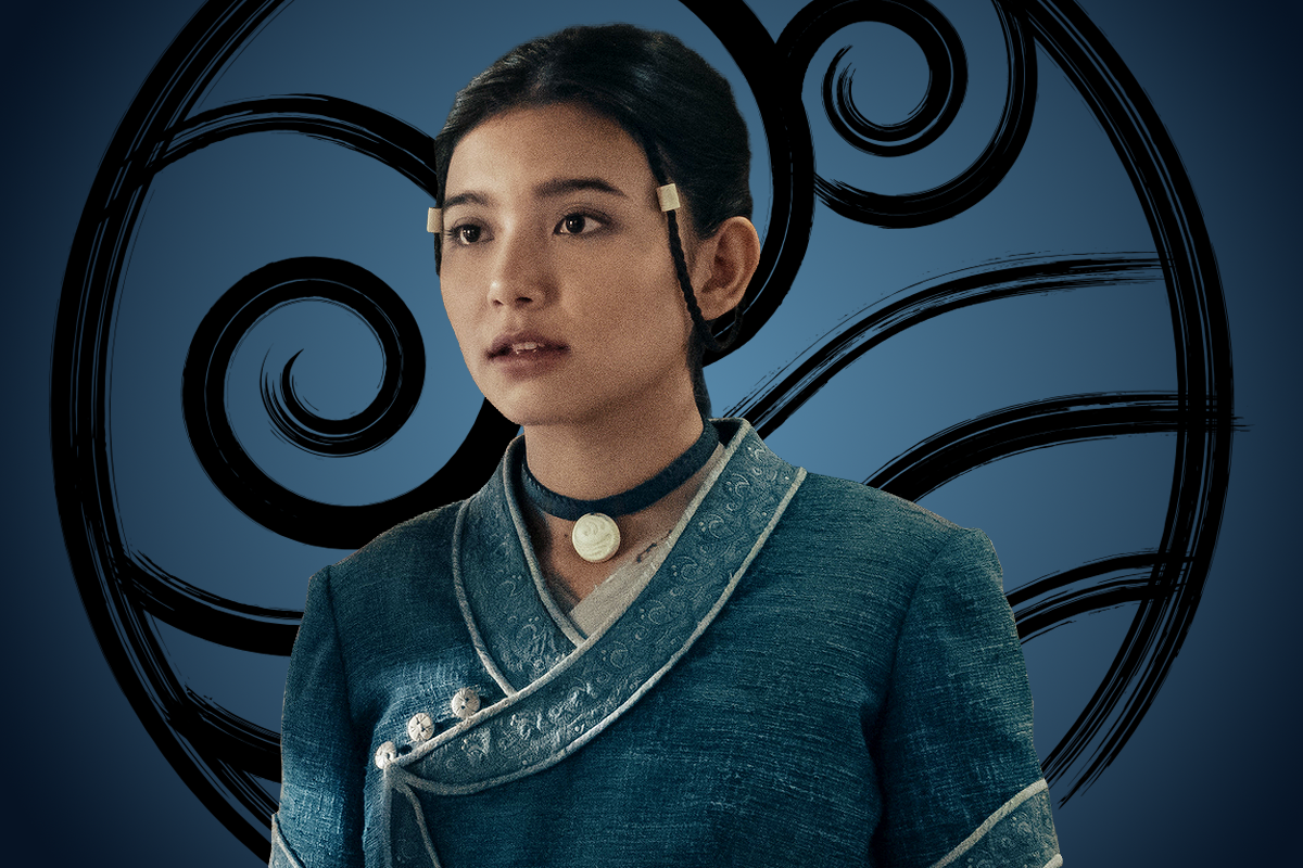 Kiawentiio as Katara wearing traditional blue clothing stands in front of a circular symbol with swirling patterns on a blue background, suggesting a fantasy or elemental setting.