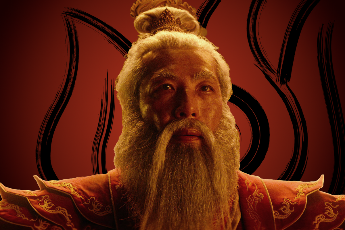 Hiro Kanagawa as Fire Lord Sozin with long white hair and beard, wearing ornate red and gold robes against a dramatic red background with black flame-like patterns, looking upward with a regal expression.