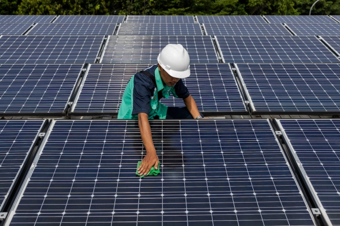 A worker is cleaning solar panels that provide partial electrical power to Istiqlal Mosque in Jakarta, Indonesia, on May 3, 2024. Photo by Nurphoto via AFP
