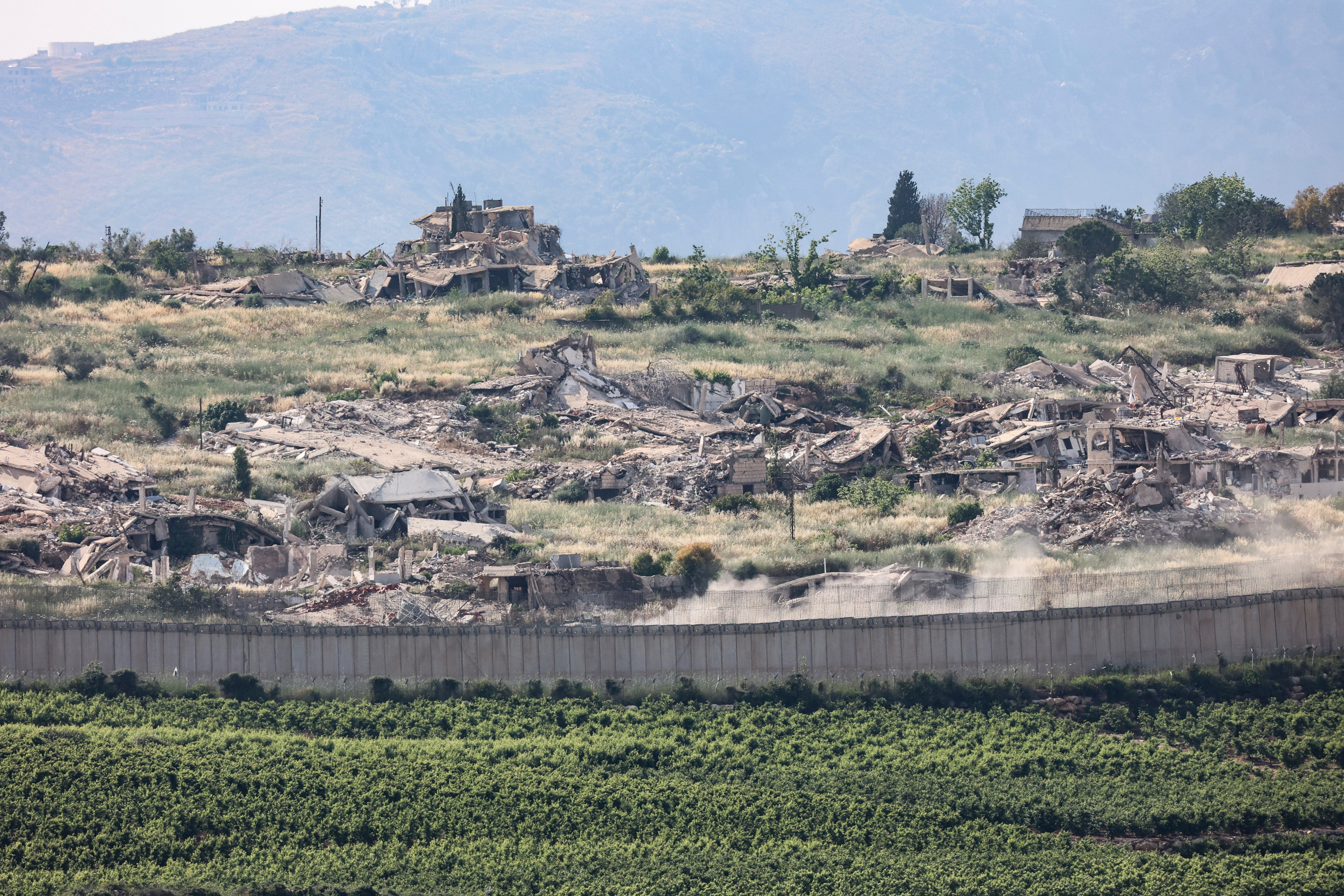 31 May 2026, ---: An Israeli military vehicle drives past destroyed houses in southern Lebanon along the Israeli-Lebanese border, as seen from northern Israel, amid ongoing hostilities between Israel and the Lebanese militant group Hezbollah. Photo by: Gil Cohen-Magen/picture-alliance/dpa/AP Images