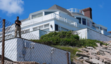 A security guard stands watch at Taylor Swift's "Holiday House," Saturday, June 20, 2026, in Westerly, R.I. (AP Photo/Robert F. Bukaty)