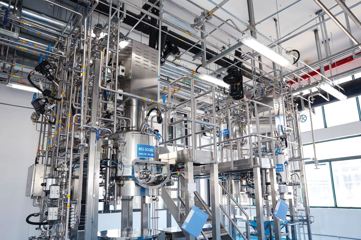 An indoor manufacturing site with an array of stainless steel equipment.