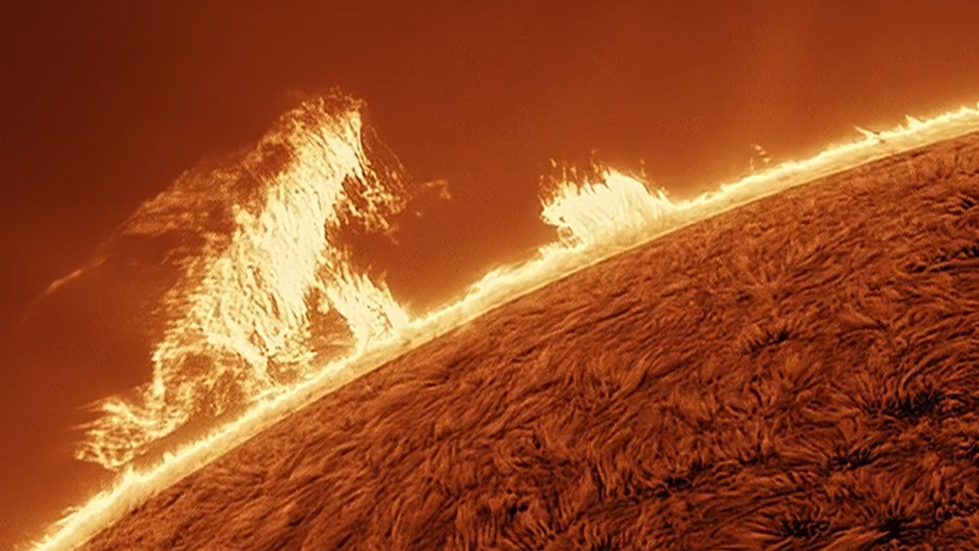 close up view of the sun shows a tall structure resembling 'Godzilla' "walking" along the edge of the sun and breathing its atomic breath!