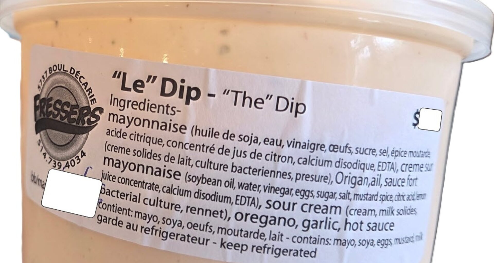 A small circular plastic container with a label sticker on the side identifying it as 'Le' Dip with a list of ingredients.