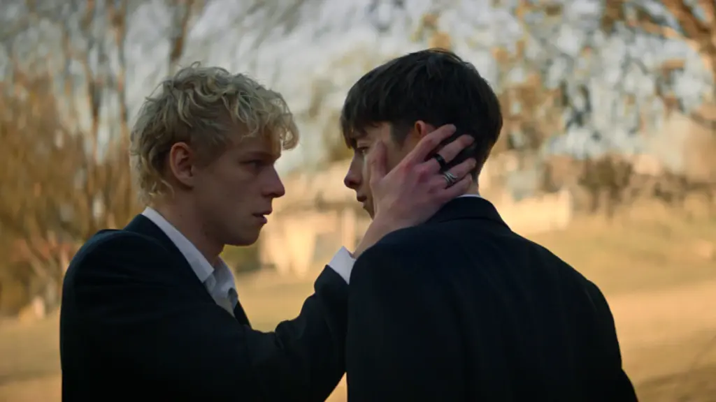 Stacy Clausen holds Joe Bird's face romantically as the two meet each other secretly in a park in the Australian queer horror movie LEVITICUS. 