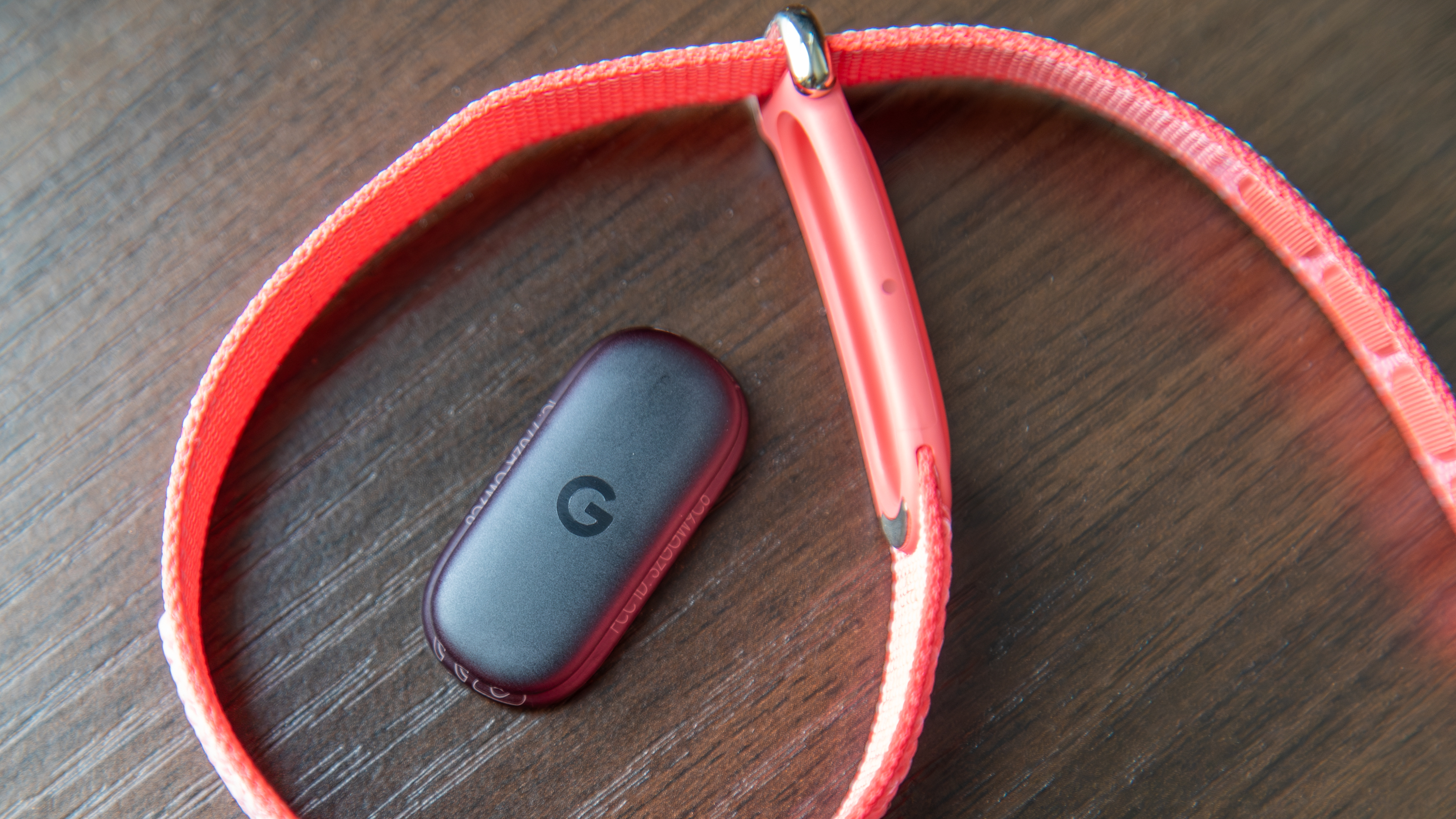 Fitbit Air band wrapped around the sensor on a table