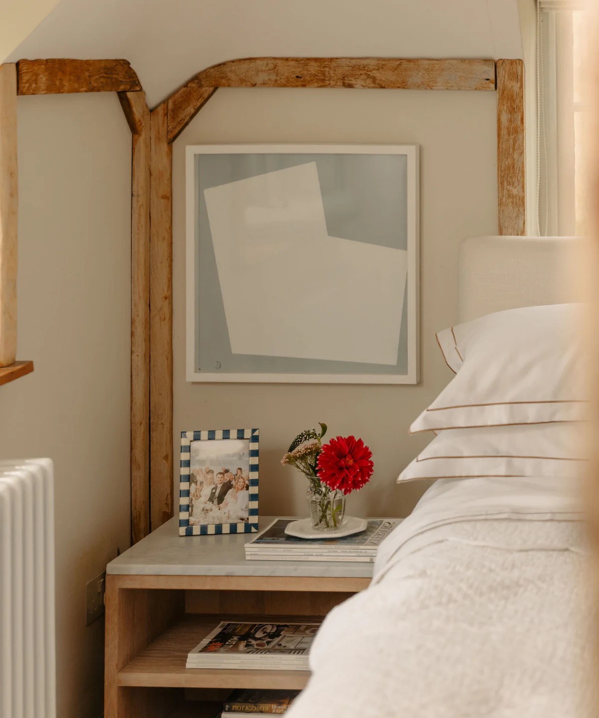 A bedside table with one framed photograph on top