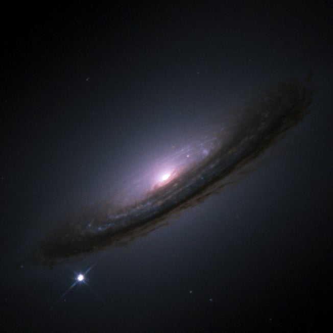 Hubble Space Telescope-Image of Supernova 1994D (SN1994D) in galaxy NGC 4526 - SN 1994D is the bright spot on the lower left (Credit : NASA/ESA)