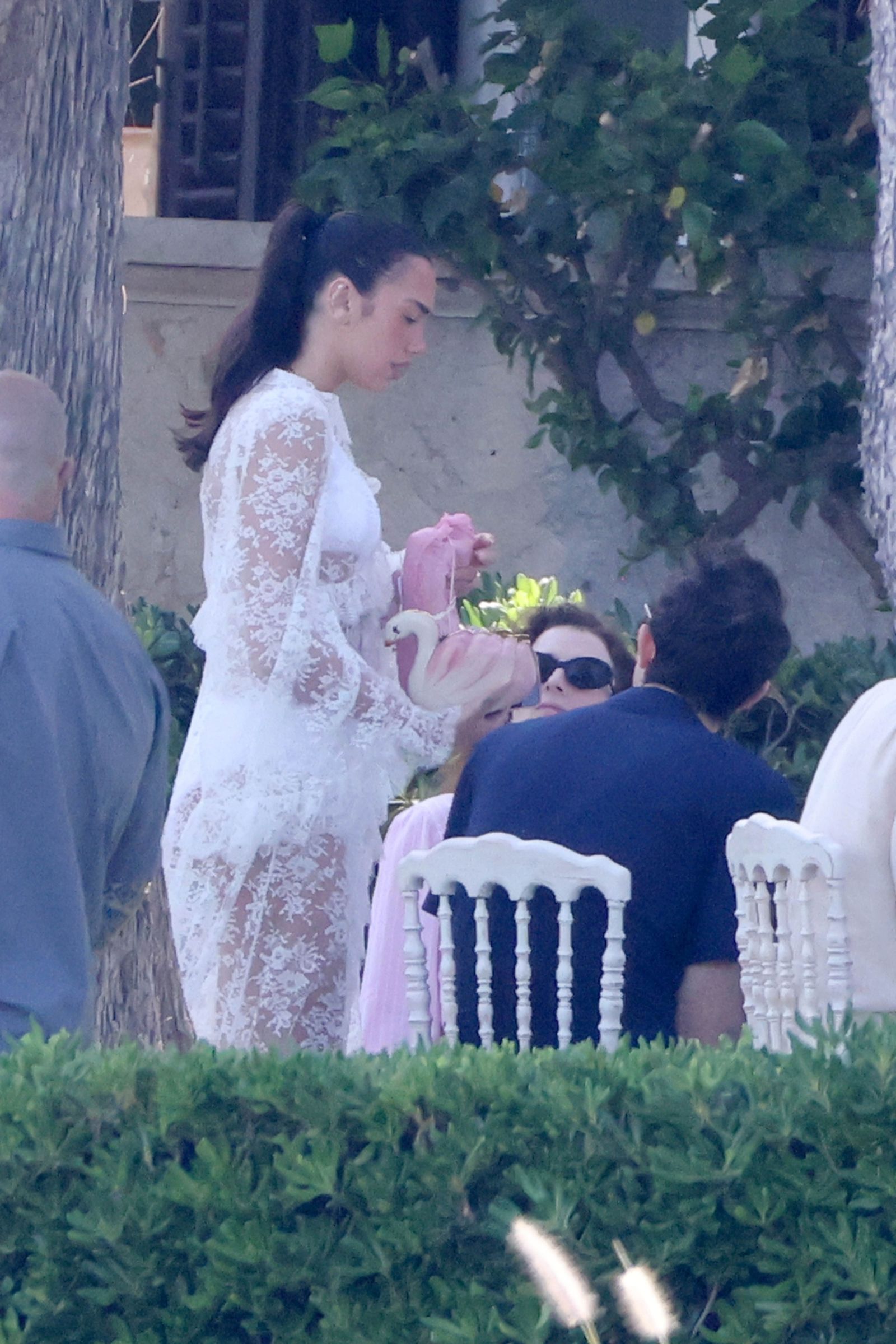 Image may contain Dua Lipa Plant Potted Plant Clothing Dress Fashion Formal Wear Gown Wedding and Wedding Gown