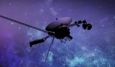 Voyager 1: A spacecraft with antenna dish and a long strut, against star clouds.