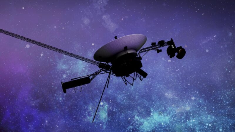 Voyager 1: A spacecraft with antenna dish and a long strut, against star clouds.