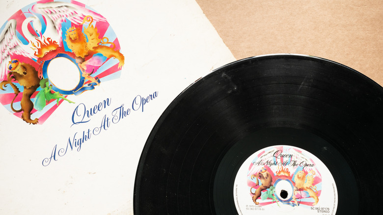 A vinyl record copy of Queen's "A Night at the Opera" next to the sleeve.