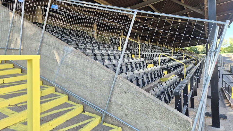 The main stand at the Harvey Hadden Stadium, with fencing preventing access.