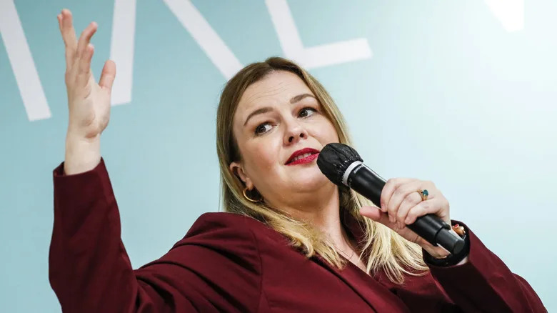 Amber Tamblyn giving a speech into a microphone