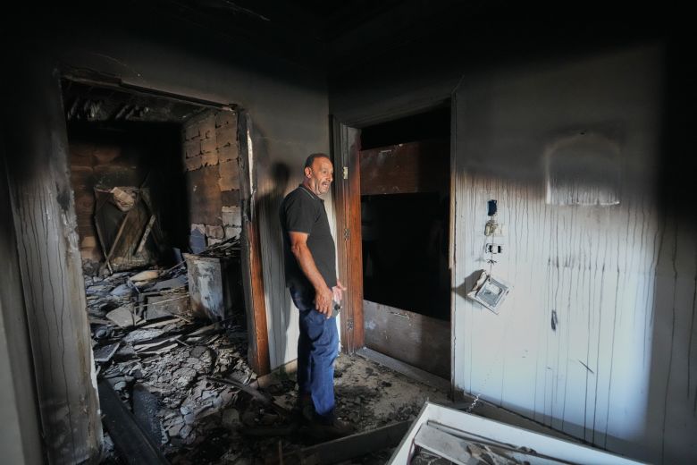 Resident Samih Haidar reacts as he inspects his burned apartment, damaged in Israeli strikes in the southern port city of Tyre, Lebanon, on June 18, 2026.
