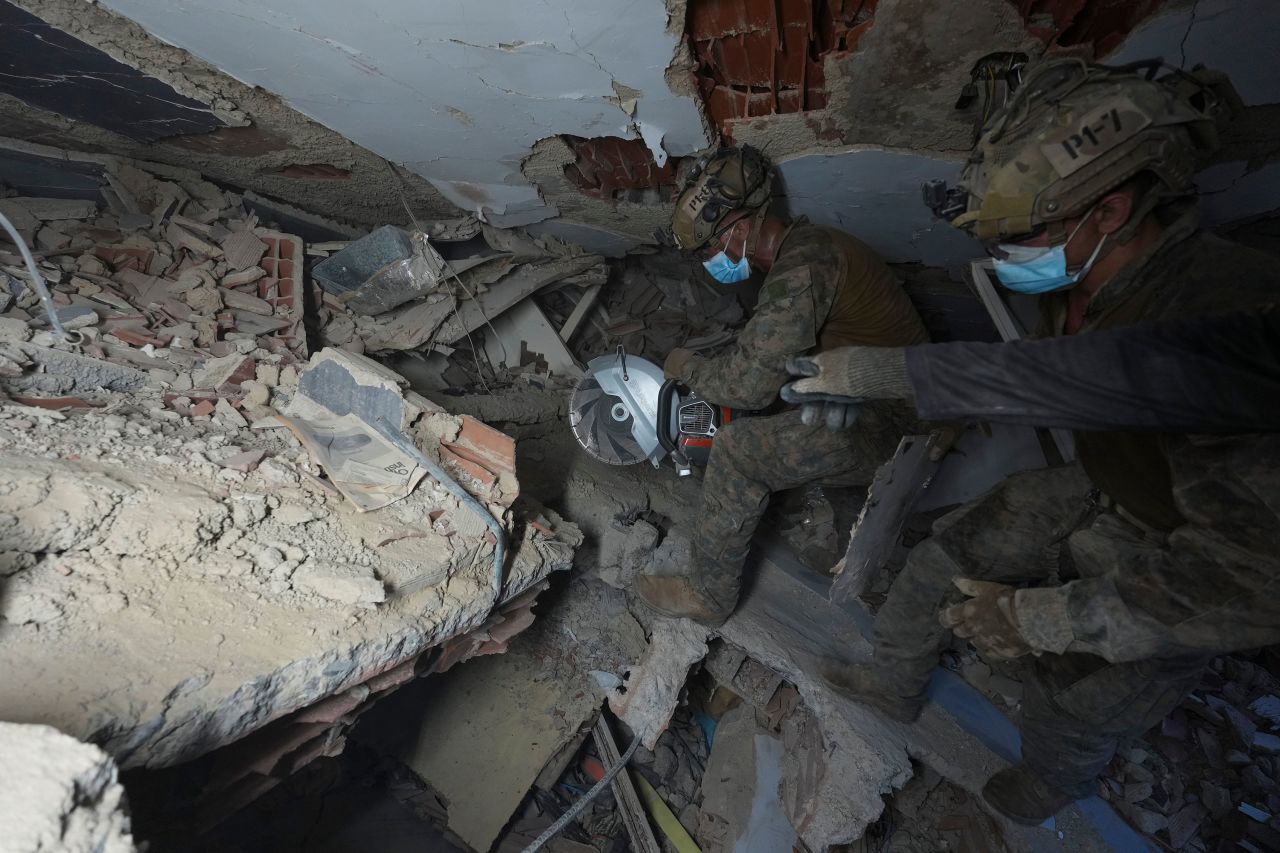 Rescuers make their way through the rubble in search of earthquake survivors in La Guaira, Venezuela, on Sunday.