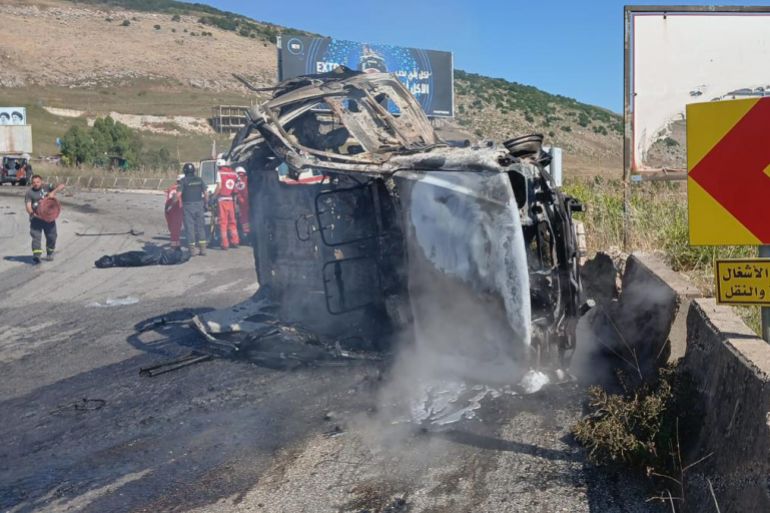 In this image released by the Lebanese Army on its official X account, Lebanese Red Cross personnel and rescue workers stand next to a destroyed vehicle after an Israeli airstrike on the road linking the city of Nabatiyeh and the town of Marjayoun, in Kfar Tebnit, Lebanon, Saturday, June 6, 2026, where, the Lebanese Army said, the vehicle belonged to the army and a brigadier general, a captain and another soldier were killed in the strike. (Lebanese Army via AP)