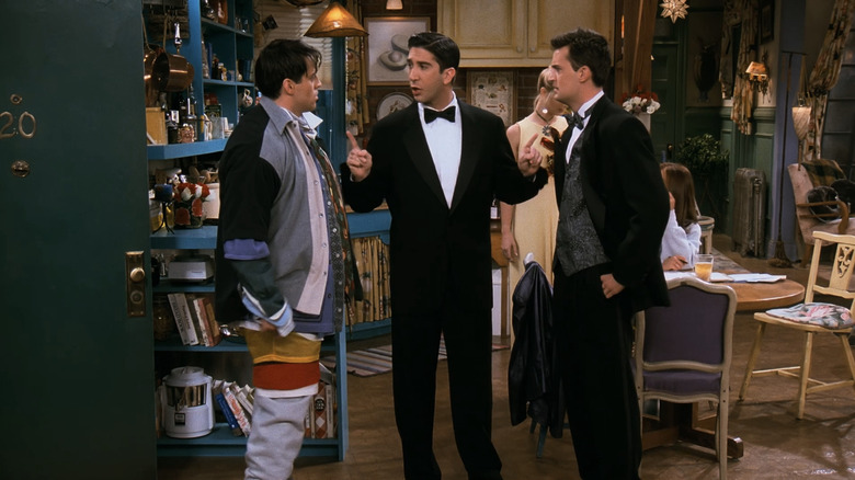 David Schwimmer's Ross Gellar stands between Matt Le Blanc's Joey Tribbiani and Matthew Perry's Chandler Bing in Friends