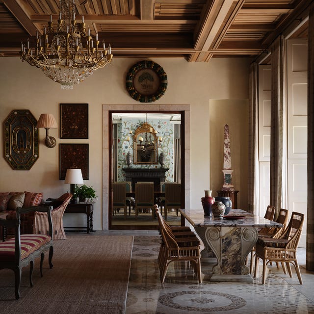 Elegant dining room with ornate chandelier and intricate wood ceiling design. Elegant dining room with ornate chandelier and intricate wood ceiling design.