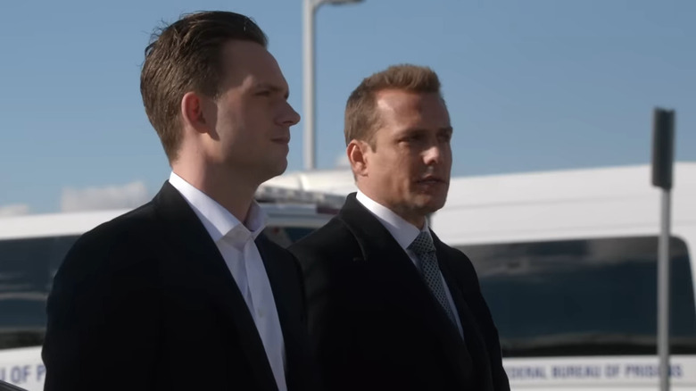 Mike Ross and Harvey Specter standing next to one another with Ross in the foreground